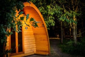 Our glamping camping pod in the evening sunshine with the oak and cherry trees in the picture