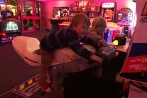 Young child laid on the arcade motorbike simulator at Skegness Arcade